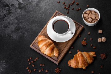 Fresh crisp delicious French croissant with a cup of fragrant coffee