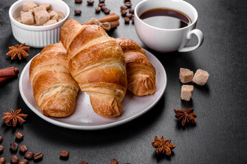 Fresh crisp delicious French croissant with a cup of fragrant coffee