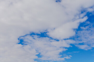 Blue sky and fluffy white clouds.