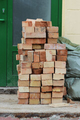 red bricks are collected in a pile at the entrance to the bank. renovation of the premises