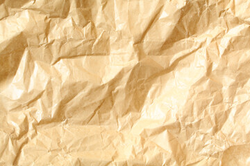 Wrinkled golden color paper background texture. Full frame pattern