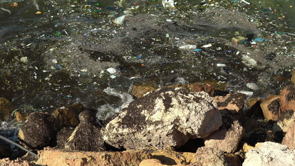 Garbage in the Mediterranean Sea. Environmental pollution. Harm to animals. Discarded garbage brought the waves ashore. Close-up