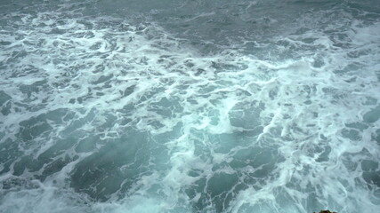 Fototapeta na wymiar View of the foaming waves of the sea. Turquoise sea