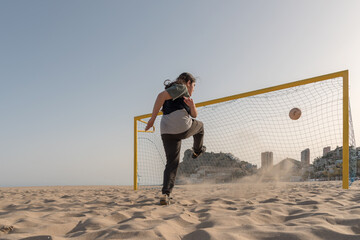 Ball arriving at the goal after being shot by a teenager.