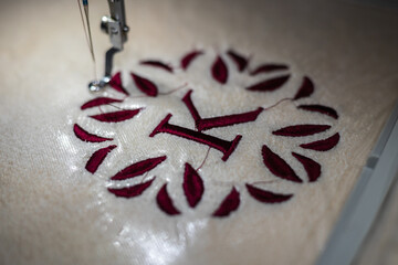 Embroidery design, alphabet monogram K. Machine Embroidery on a cotton towel with burgundy color....