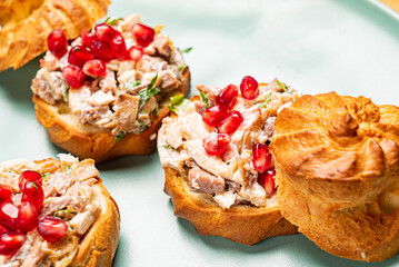 canape with meat salad and pomegranate seeds