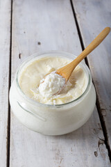 Traditional creamy yoghurt. Turkish and Greek traditional dairy food yogurt or yoghurt in bowl on wooden background.