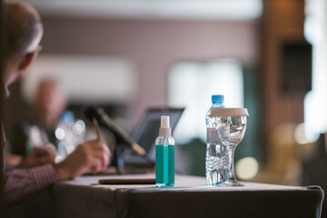 disinfecting liquid on table during business seminar