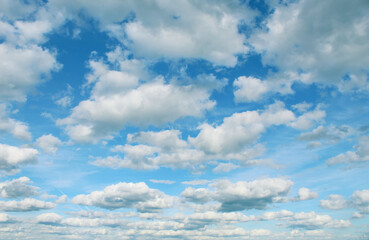 Fluffy white clouds in blue sky