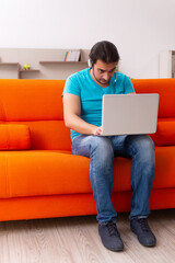 Young male student in tele-studying concept during pandemic