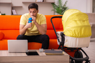 Young man looking after new born at home