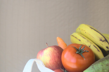 Closeup view of tomatoes and other fruits and vegetables with copy space