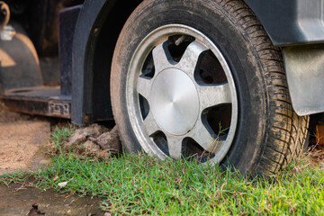 Fototapeta na wymiar Flat car tires abandoned on the lawn