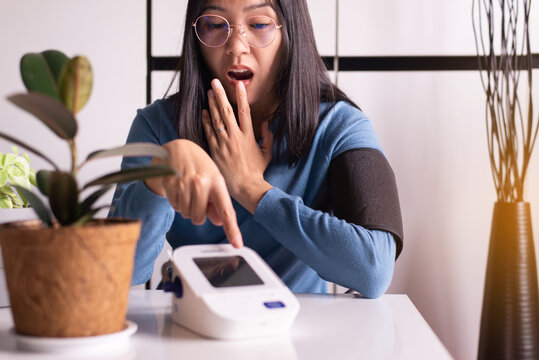 Patient woman health check blood pressure & heart rate monitors in yourself at home