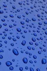 Water drop on blue surface