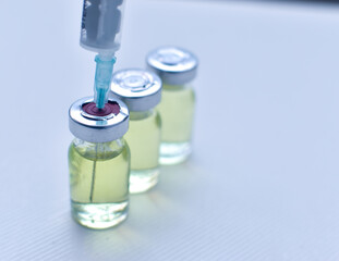 Vial of drugs injection or vaccine with syringe needle on a white background for cure and prevention of sickness 