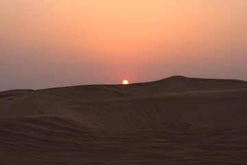Plakat Little girl looking at the Sunset at Dubai's Desert by Christian Gintner