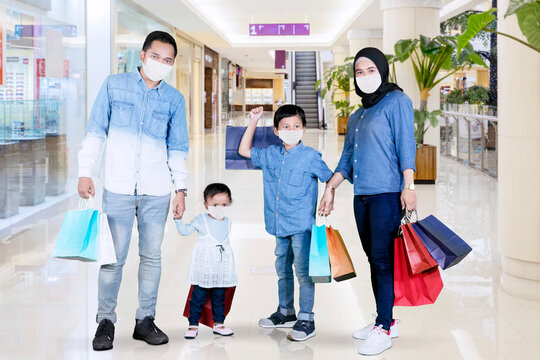 Muslim family wear face mask while shopping in mall