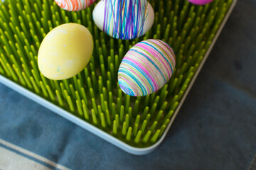 Easter eggs created by a young child: some eggs are dyed while others have stripes on them made by...