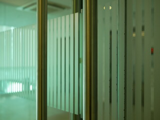 Obraz premium closeup of metal handles with glass door in the office. 