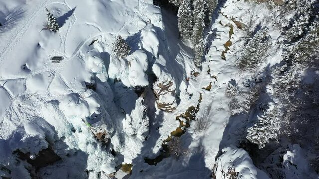 Aerial view of Ouray Ice Park, southwestern Colorado, snow capped cliffs, frozen waterfalls, area for climbing and hiking, bridseye drone shot