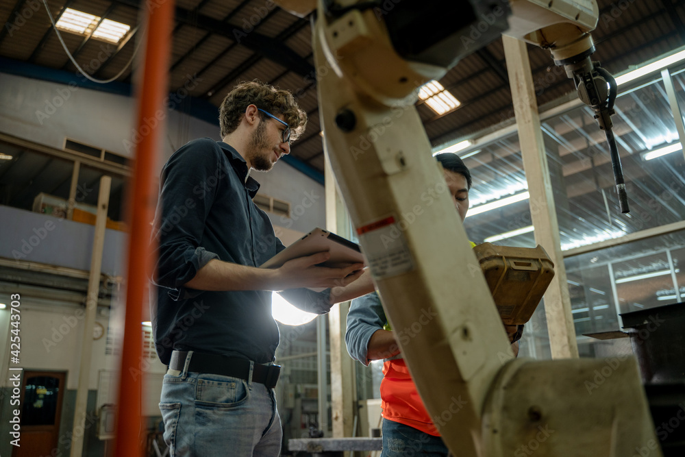 Poster factory engineer working together and having discussion in factory,technical specialist mechanics at
