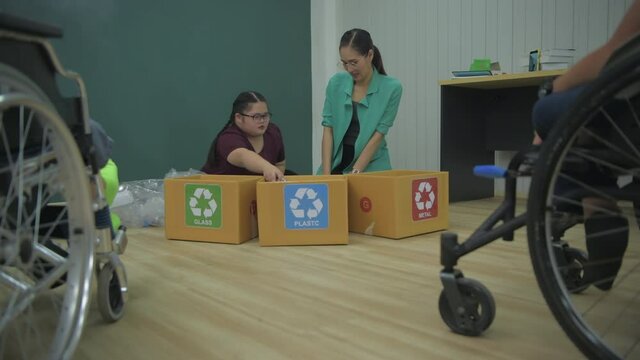 Education concept of 4k Resolution. Teacher teaches disabled children to sort garbage.