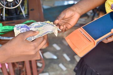 Point of sales known as POS terminal device used for cash naira transaction in a tailoring shop ...