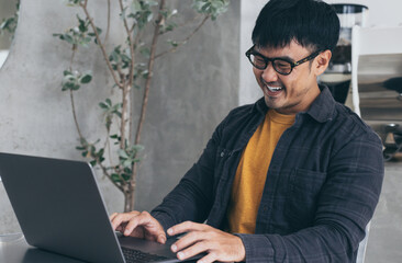 asian man work using computer hand typing laptop keyboard contact us.student study learning education online.adult professional people chatting search at office.concept for technology device business