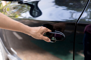 Hand on handle Close up of women hand opening car door