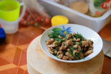 Thai food stir-fried pork with vegetables in a ceramic dish Placed on a wooden cutting board, Thai food