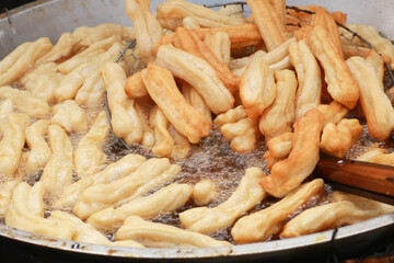 Youtiao is a long golden-brown deep-fried strip of dough commonly eaten in China and (by a variety of other names) in other East and Southeast Asian cuisines. In indonesia, they are called cakwe.