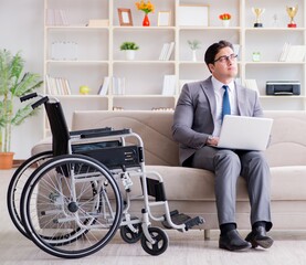 Dsabled businessman on wheelchair working home