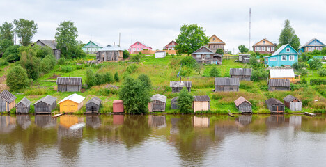 Fototapeta na wymiar Boat houses along river in Russia