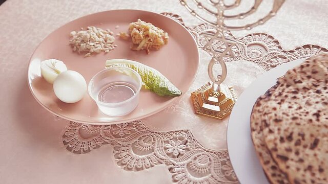 Matza shmura round for Easter seder next to kiara and menorah rotates in a circle