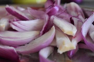 Fototapeta na wymiar Slices of red onion closeup background