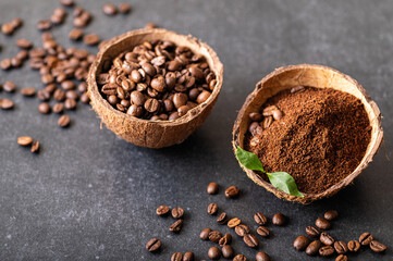 black coffee beans arabica, freshly ground aromatic in a coconut bowl, close-up