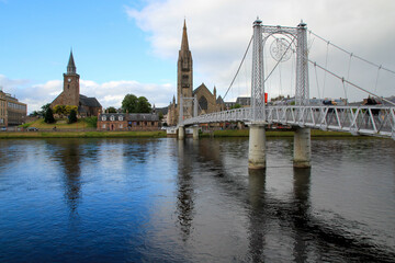 Bridge and Church of Inverness Scotland with Blue Sky Reflected in River