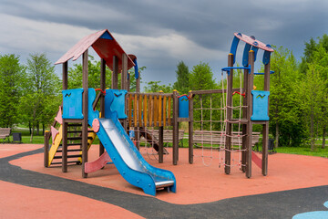 empty kids play ground in public park, rainy weather