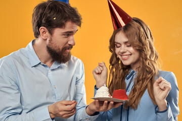 Birthday party man and woman fun yellow background cap holiday