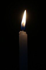 Stock photo of brightly lit candles providing light in the dark during power cuts. suitable for...