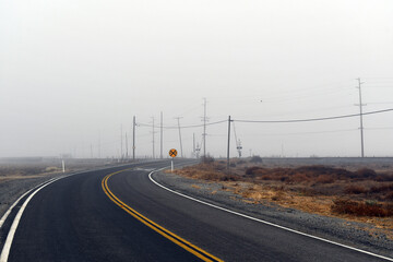 landscape shot of an empty road in fog
