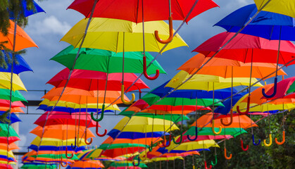 Beautiful colorful umbrellas. Street decoration with umbrellas. Lots of colorful umbrellas in the central square.