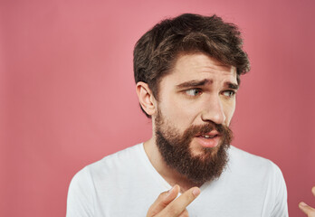 Man emotions sadness white t-shirt pink background