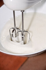 Making a cake: photo catching the movement of an electric whisk used to mixer eggs.