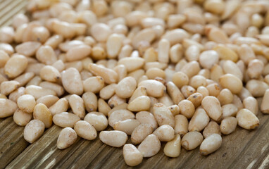 Picture of wooden desk with raw pine nut, no people
