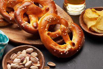 Lager beer, nuts, potato chips and fresh homemade pretzel