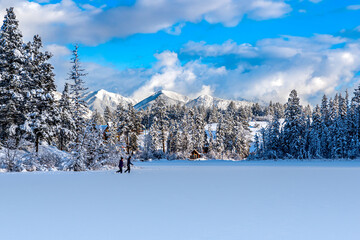 Cross Country skiers on a newly frozen Lake Lillian near Invermere, BC, Canada