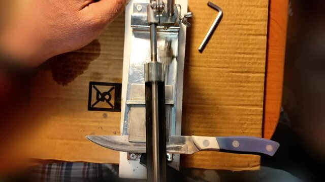 Sharpening a knife.Close-up, male hands sharpening a knife. video