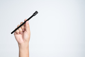 Hand holding self lock plastic cable